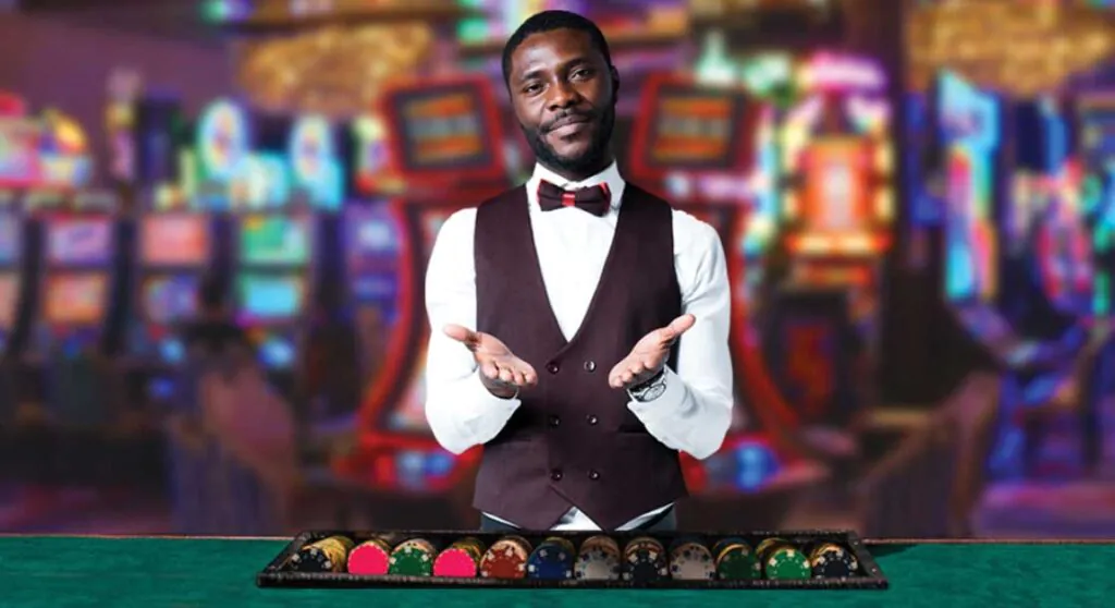 The croupier stands in front of the poker table with his palms outstretched, as if inviting you to play with him in the casino